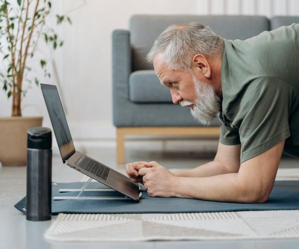 A calm home office setting with a yoga mat rolled out nearby, suggesting an integrated wellness routine.